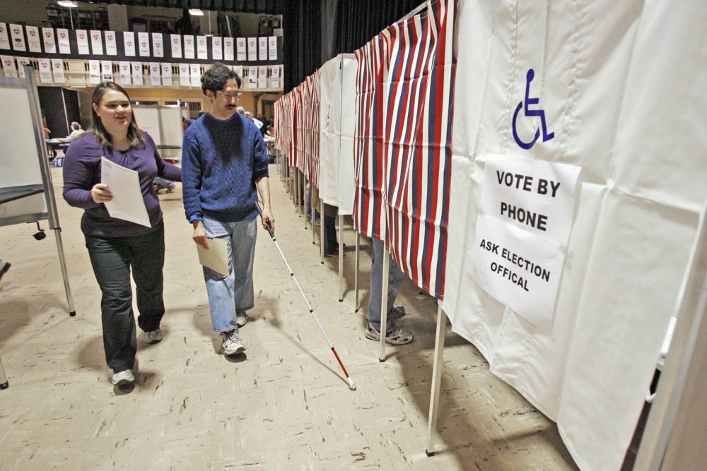 The voting rights of America's disabled citizens must be dealt with now, writes Ross Doerr. Pictured: A blind man is helped to a voting booth by an  election worker in Montpelier, Vt. (Toby Talbot/AP)