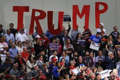 Supporters hold signs for Republican presidential candidate Donald Trump campaign rally in Grand Rapids, Mich., Tuesday, Nov. 8, 2016. (/Paul Sancya/AP)