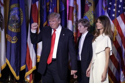 President-elect Donald Trump pumps his fist after giving his acceptance speech as his wife Melania Trump, right, and their son Barron Trump follow him during his election night rally. (John Locher/AP)