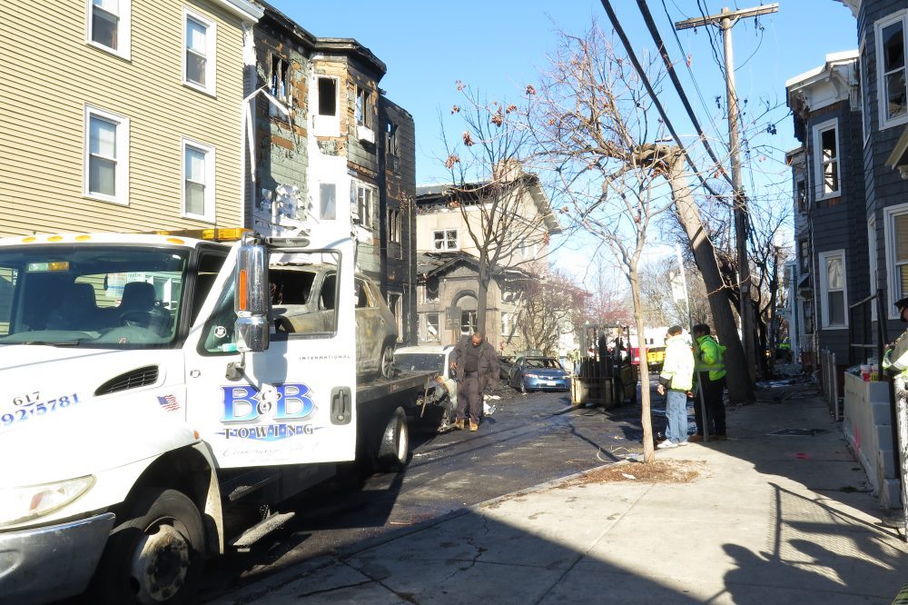 The view on Berkshire Street in East Cambridge Sunday afternoon as crews started cleaning up from Saturday's 10-alarm fire. (Simón Rios/WBUR)