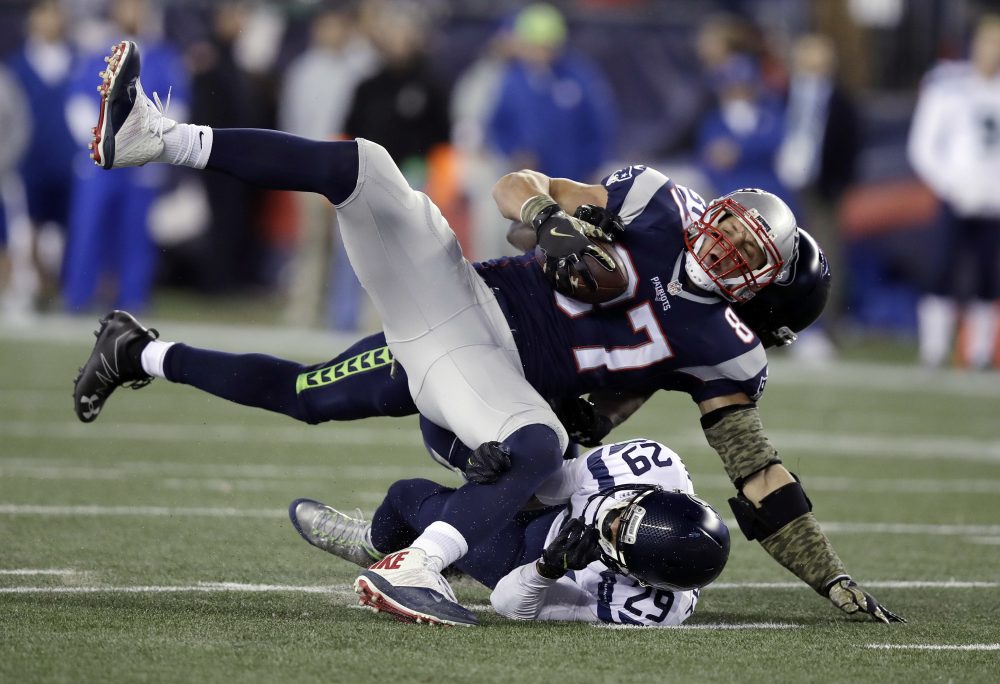 Seattle Seahawks safeties Earl Thomas (29) and Kam Chancellor, rear, tackle New England Patriots tight end Rob Gronkowski (87) during a game on Nov. 13 in Foxborough, Mass. (Charles Krupa/AP)