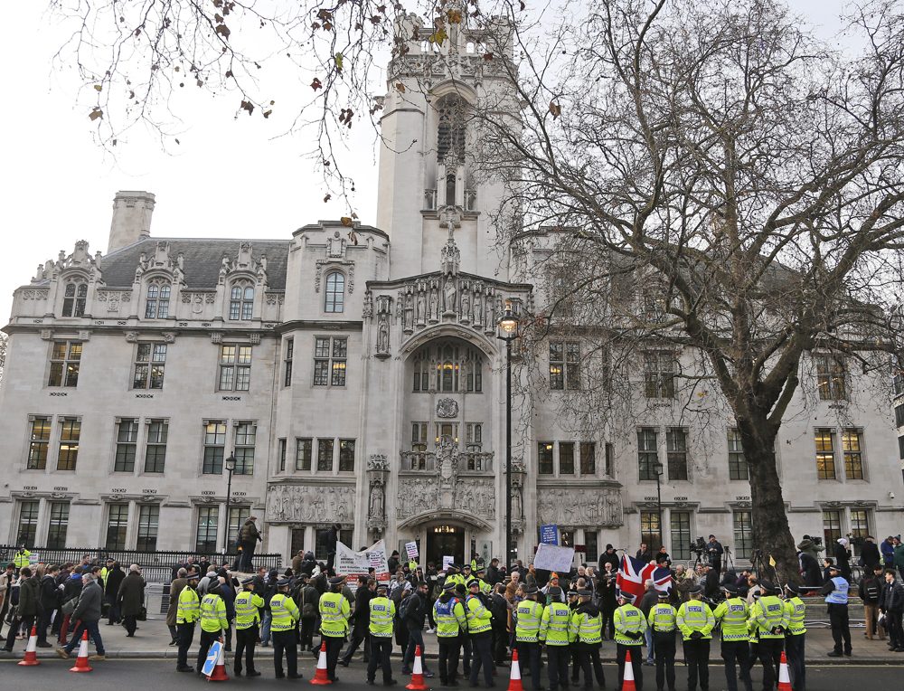 Police forces separate demonstrators in front of the Supreme Court in London, Monday, Dec. 5, 2016. (Frank Augstei/AP)