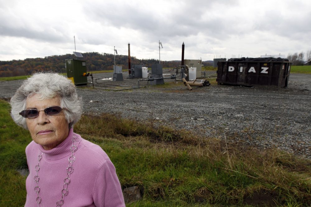 Jean Carter poses for a photograph on her property with a gas well next door Friday, Oct. 14, 2011 in Dimock, Pa. State regulators blame faulty gas wells drilled by Cabot Oil & Gas Corp for leaking methane into the groundwater in Dimock, Pa. (Alex Brandon/AP)