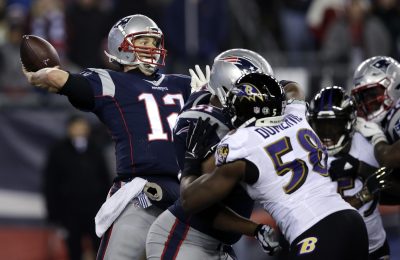 New England Patriots quarterback Tom Brady (12) throws a touchdown pass to Chris Hogan under pressure from Baltimore Ravens linebacker Elvis Dumervil (58) during the fourth quarter of an NFL football game, Monday, Dec. 12, 2016, in Foxborough, Mass. (Charles Krupa/AP)