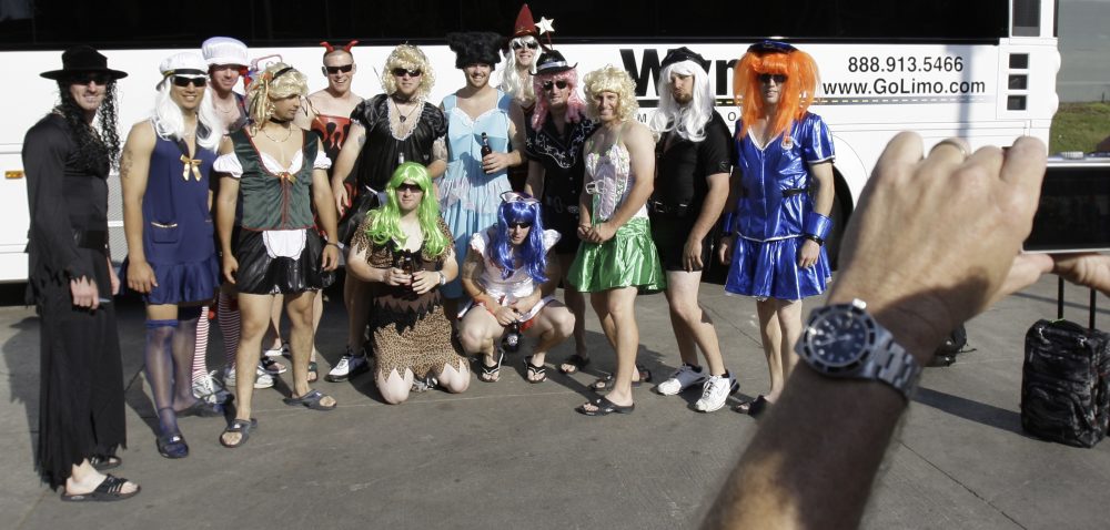 In this Sept. 24, 2008, file photo, Oakland Athletics rookie players dressed in costumes line up for a photo before boarding the team bus after their 14-4 loss to the Texas Rangers, in Arlington, Texas. That hazing ritual of dressing up rookies as Wonder Woman, Hooters Girls and Dallas Cowboys cheerleaders is now banned. (LM Otero/AP)