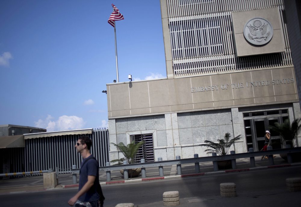 A man walks past the U.S. Embassy in Tel Aviv, Israel, in 2013. (Ariel Schalit/AP)