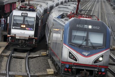 An Amtrak train passes a New Jersey Transit train stopped to discharge and board passengers at Elizabeth train station Saturday, March 12, 2016, in Elizabeth, N.J., along Amtrak's Northeast Corridor. (Mel Evans/AP)