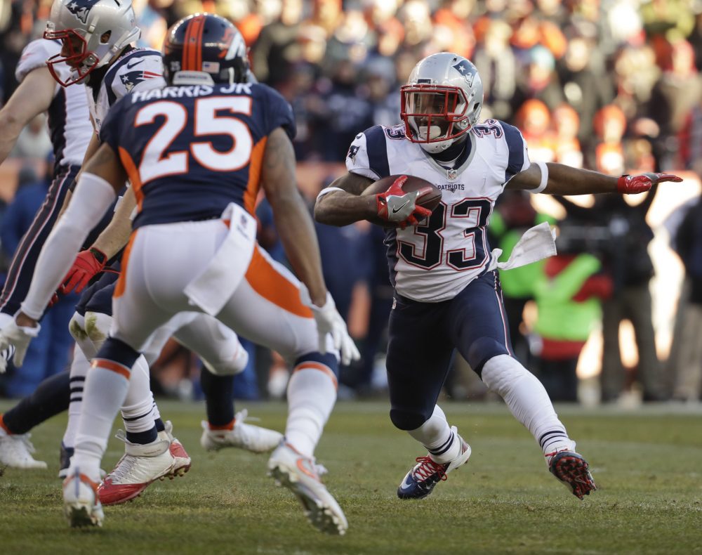 New England Patriots running back Dion Lewis runs against the Denver Broncos during the first half of an NFL football game on Sunday in Denver. (Jack Dempsey/AP)