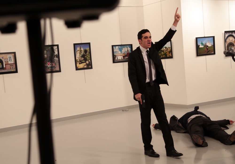 An unnamed gunman gestures after shooting the Russian Ambassador to Turkey, Andrei Karlov, at a photo gallery in Ankara, Turkey, Monday, Dec. 19, 2016. A Russian official says that the country's ambassador to Turkey has died after being shot by a gunman in Ankara. (Burhan Ozbilici/AP)