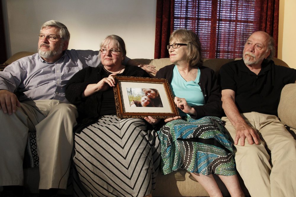 From left: Patrick Boyle, Linda Boyle, Lyn Coleman and Jim Coleman hold a photo of their kidnapped children, Joshua Boyle and Caitlan Coleman, who were taken by the Taliban in late 2012, on June 4, 2014, in Stewartstown, Pa. (Bill Gorman/AP)