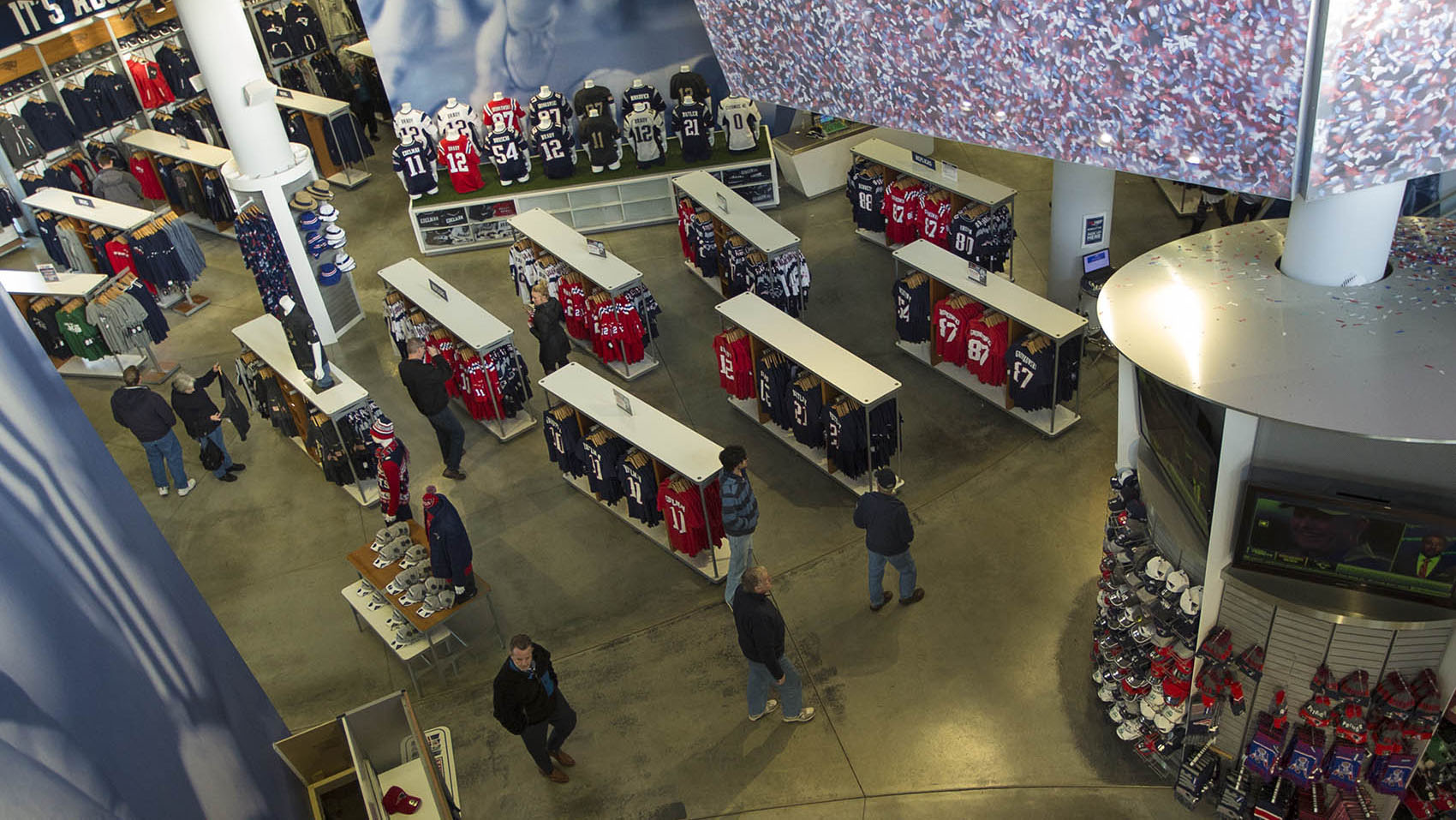 A birds-eye view of shoppers perusing the racks of Patriots jerseys and other apparel at the pro shop at Patriot Place. (Jesse Costa/WBUR)