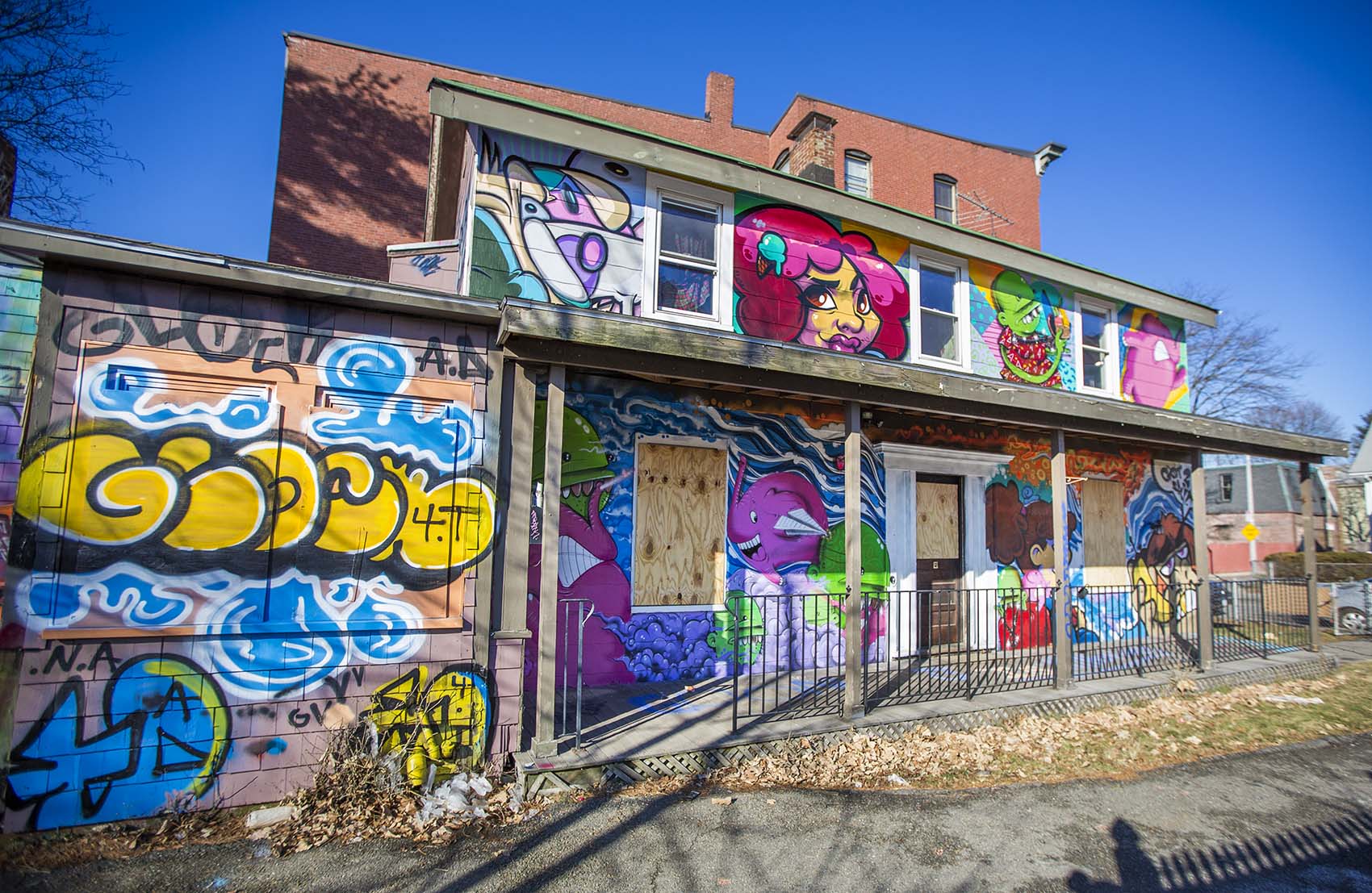 Empty house covered by graffiti at 197 Green St., Jamaica Plain, Boston. (Jesse Costa/WBUR)