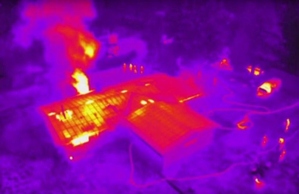 The view from a UAV's thermal imaging camera, above the scene of a house fire. (Courtesy via KQED)