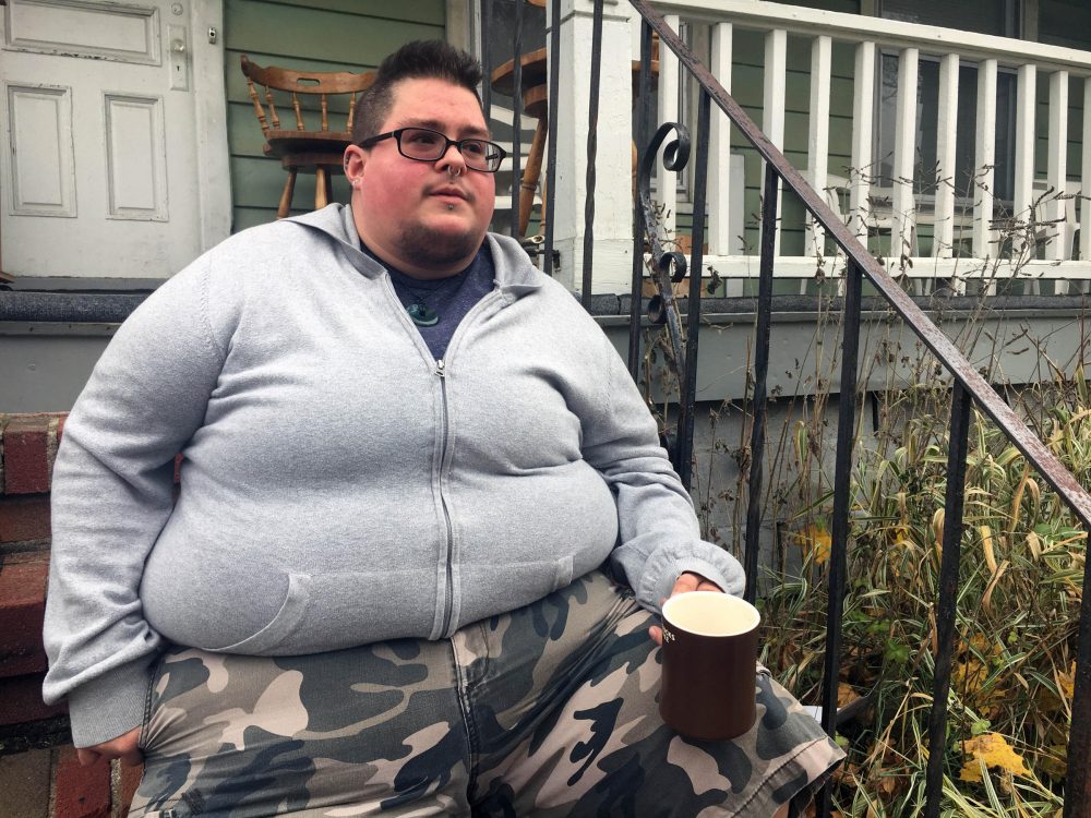 A Rochester, N.Y., native sits on his porch right before going to a name and gender change legal clinic hosted by the Empire Justice Center. (Karen Shakerdge/WXXI)