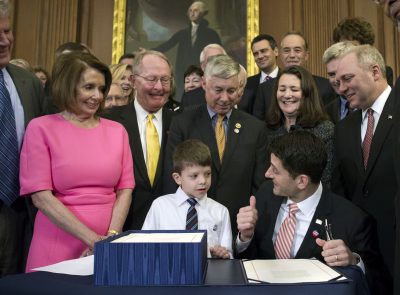 House Speaker Paul Ryan of Wis. gives a thumbs-up to 7-year-old Max Schill, who suffers from Noonan Syndrome, after signing the 21st Century Cures Act, Thursday in Washington. Watching, from left are, House Minority Leader Nancy Pelosi of Calif., Sen. Lamar Alexander, R-Tenn., Rep. Fred Upton, R-Mich., Rep. Diana DeGette, D-Colo. and House Majority Whip Steve Scalise of La. (Cliff Owen/AP)