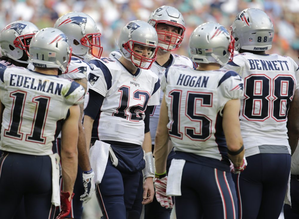 New England Patriots quarterback Tom Brady (12) talks to offensive players on the field, during the second half of an NFL football game against the Miami Dolphins on Sunday in Miami Gardens, Fla. (Lynne Sladky/AP)