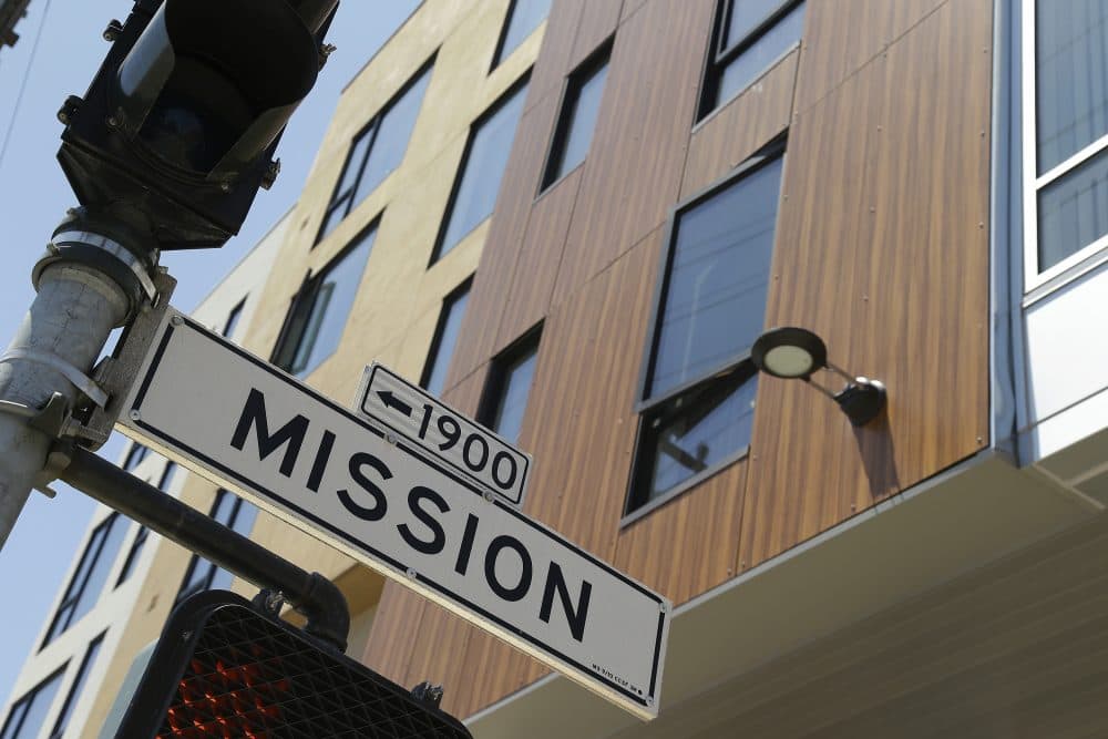 A street sign hangs outside a then-new apartment building on Mission Street, Tuesday, June 2, 2015, in San Francisco. (Eric Risberg/AP)