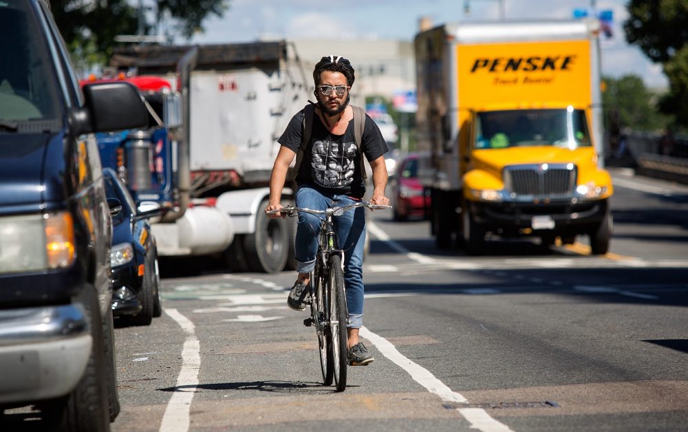 A bicyclist rides down the bike lane on Massachusetts Avenue in Boston. (Robin Lubbock/WBUR)