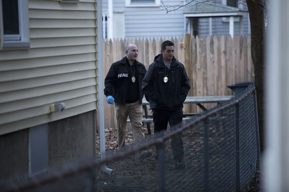 Somerville detectives examine the area where fugitive James Morales was captured, in the backyard of 85 Wheatland St. (Jesse Costa/WBUR)