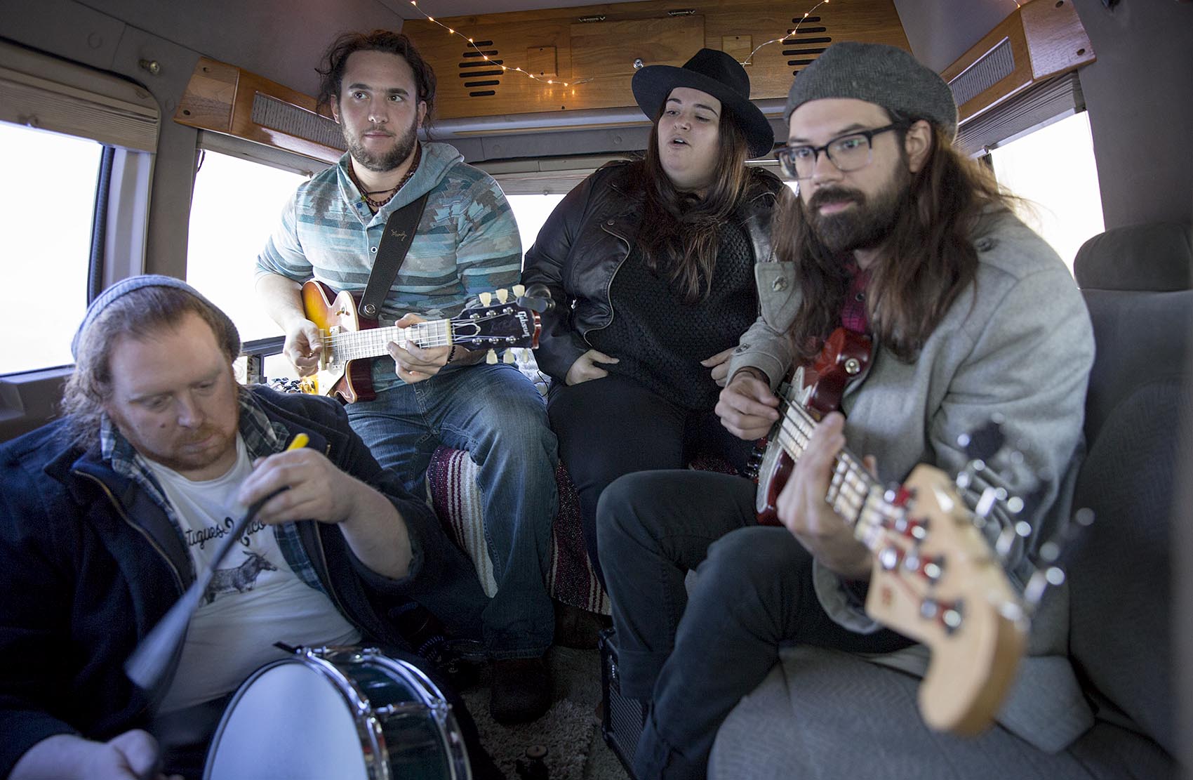 Julie Rhodes and her band play &quot;Holes&quot; in their tour bus. (Robin Lubbock/WBUR)