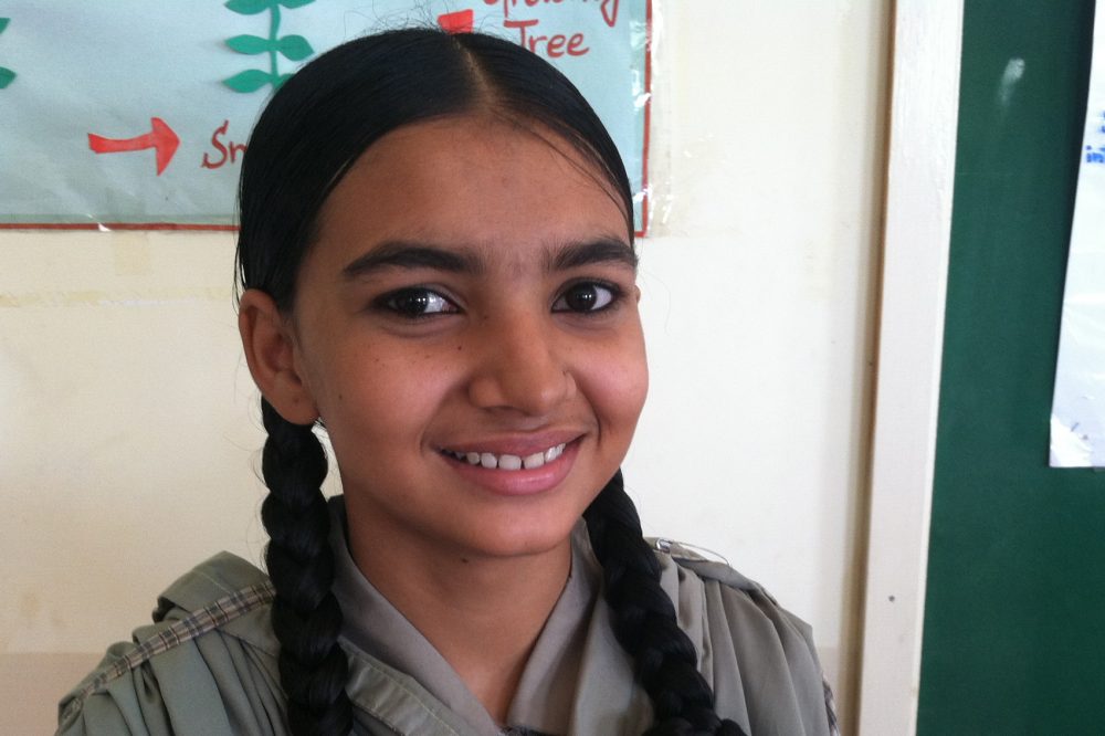 Rizwana Ruab, 16, attends the ninth grade at one of the schools with Developments in Literacy in Orangi. She is studying biology so she can become a police officer. She spends several hours every day making shoes with her family. She earns on average about 20 U.S. cents an hour. (Laura Isensee/Houston Public Media)