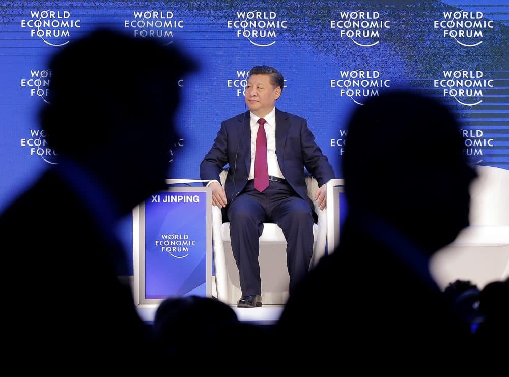 China's President Xi Jinping sits on the podium while people leave at the World Economic Forum in Davos, Switzerland, Tuesday, Jan. 17, 2017. (Michel Euler/AP)