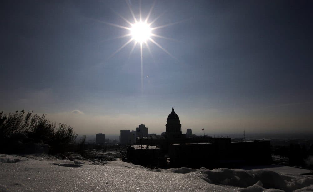 The silhouette of Utah State Capitol is shown against the blue sky and particulates from an inversion Wednesday, Jan. 2, 2013, in Salt Lake City. (Rick Bowmer/AP)