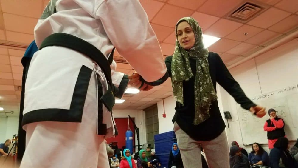 Iram Baig practices with an instructor during a self-defense course for Muslim women in College Park, Md. (Carmel Delshad/WAMU)