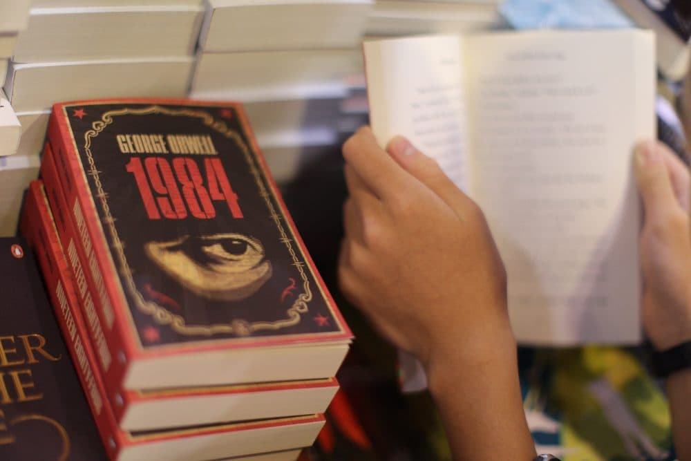 A boy reads a book next to copies of George Orwell's &quot;1984&quot; at Hong Kong's annual book fair in July 2015. (Aaron Tam/AFP/Getty Images)