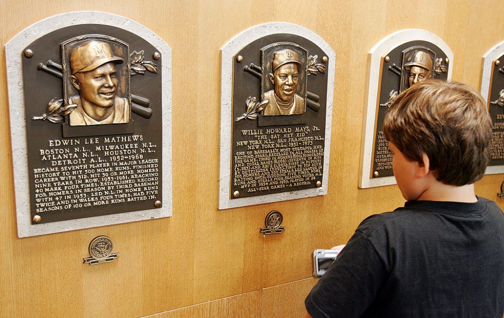 A young baseball fan looks at plaques of players inducted into the National Baseball Hall of Fame and Museum on July 26, 2008 in Cooperstown, N.Y. (Jim McIsaac/Getty Images)