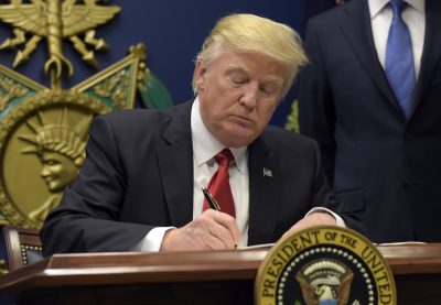 President Donald Trump signs an executive order on &quot;extreme vetting&quot; during an event at the Pentagon Friday. (Susan Walsh/AP)