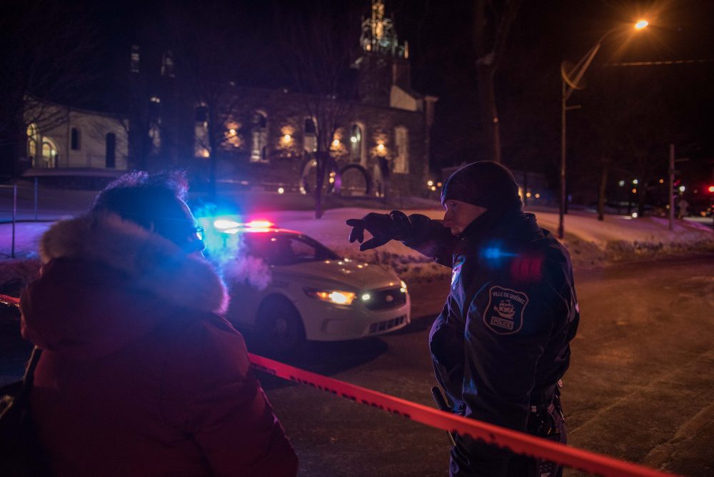 A Canadian police officer talks to a woman after a shooting in a mosque at the Quebec City Islamic cultural center on Sainte-Foy Street in Quebec City on Jan. 29, 2017. (Alice Chiche/AFP/Getty Images)