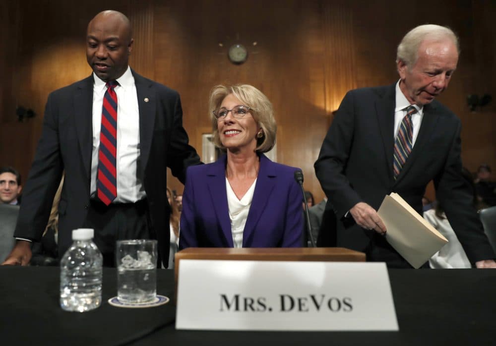 Education Secretary-designate Betsy DeVos arrives with former Sen. Joe Lieberman, right, and Sen. Tim Scott, R-S.C., before testifying on Capitol Hill in Washington, Tuesday, Jan. 17, 2017, at her confirmation hearing before the Senate Health, Education, Labor and Pensions Committee. (AP Photo/Carolyn Kaster)