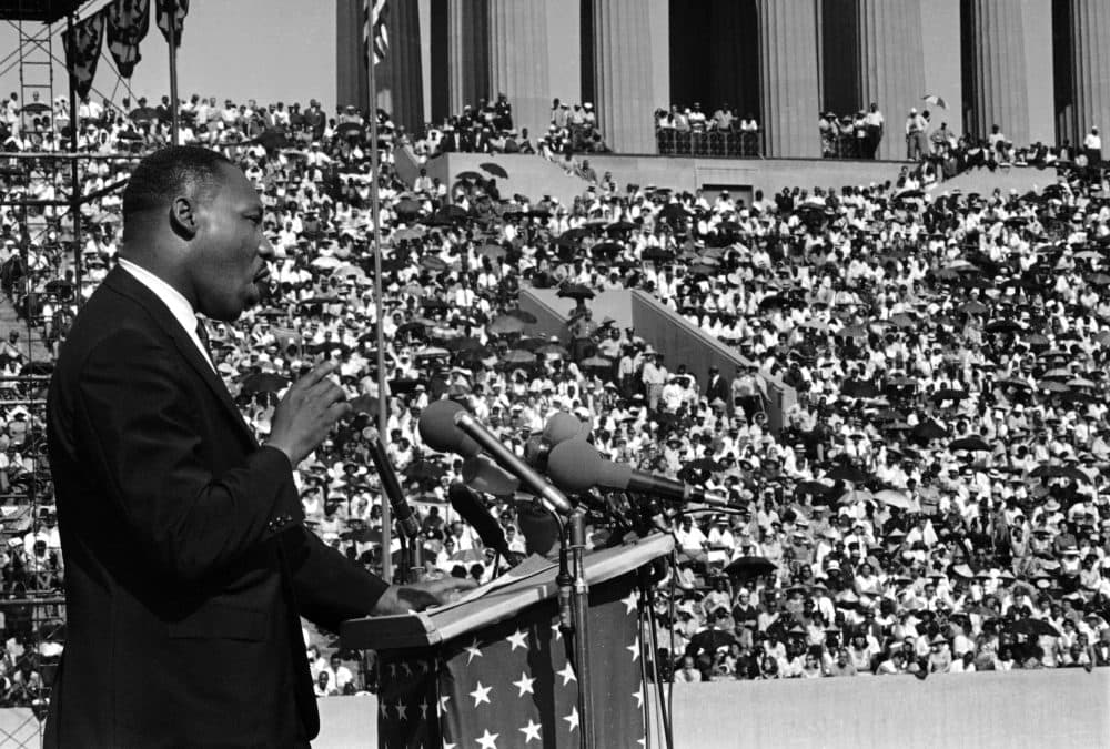 The Rev. Martin Luther King addresses a crowd estimated at 70,000 at a civil rights rally in Chicagos Soldier Field June 21, 1964. King told the rally that congressional approval of civil rights legislation heralds the dawn of a new hope for the Negro. (Charles E. Knoblock/AP)