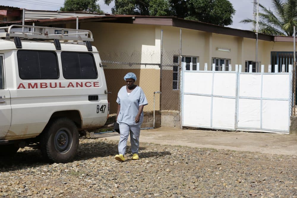 A nurse walks past an ambulance at the government hospital in Kenema, Sierra Leone, during the Ebola outbreak. (Sunday Alamba/AP)