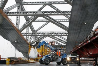 In this Nov. 15, 2016, file photo, a worker lifts materials as construction continues on the new roadway deck of the Bayonne Bridge in Bayonne, N.J. Even as they maneuver for a share of the $1 trillion in spending President-elect Donald Trump promised to rebuild America’s roads, bridges and airports, lobbyists for transportation and utility industries are beginning to wonder whether Trump really meant what he said. From the day he formally entered the presidential race to the moment he declared victory, Trump pledged to rebuild the nation’s aging and inadequate infrastructure. (Mel Evans/AP)