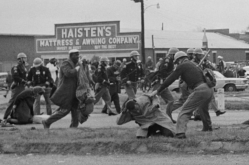 State troopers swing billy clubs to break up a civil rights voting march in Selma, Alabama on March 7, 1965. John Lewis, who was then the chairman of the Student Nonviolent Coordinating Committee is being beaten by a state trooper. (AP Photo)