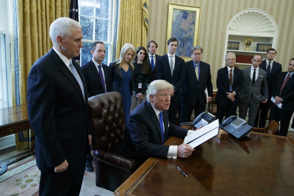 Trump’s incoming White House team of policy staff and advisors will pale to that of his predecessors, literally, writes Kevin C. Peterson. For many, it will represent a step backward from hard-earned racial and gender progress. Pictured: President Donald Trump, accompanied by Vice President Mike Pence, and staff, talks with reporters in the Oval Office of the White House in Washington, Tuesday, Jan. 24, 2017, before signing an executive order on the Dakota Access pipeline. (Evan Vucci/AP)