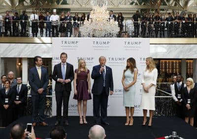 We may never know the extent of his conflicts, writes Wendy Kaminer, but we do know enough to be alarmed.
Pictured: In this photo dated Oct. 26, 2016, then-Republican presidential candidate Donald Trump, accompanied by, from left, Donald Trump Jr., Eric Trump, Trump, Melania Trump, Tiffany Trump and Ivanka Trump, speaks during the grand opening of the Trump International Hotel, the old post office, in Washington. A Trump lawyer and an aide have said that the president-elect will set up a blind trust to avoid conflicts of interest, but that is not possible given his plans to hand control of his business to three of his adult children, not a trustee. (Evan Vucci/ AP)
