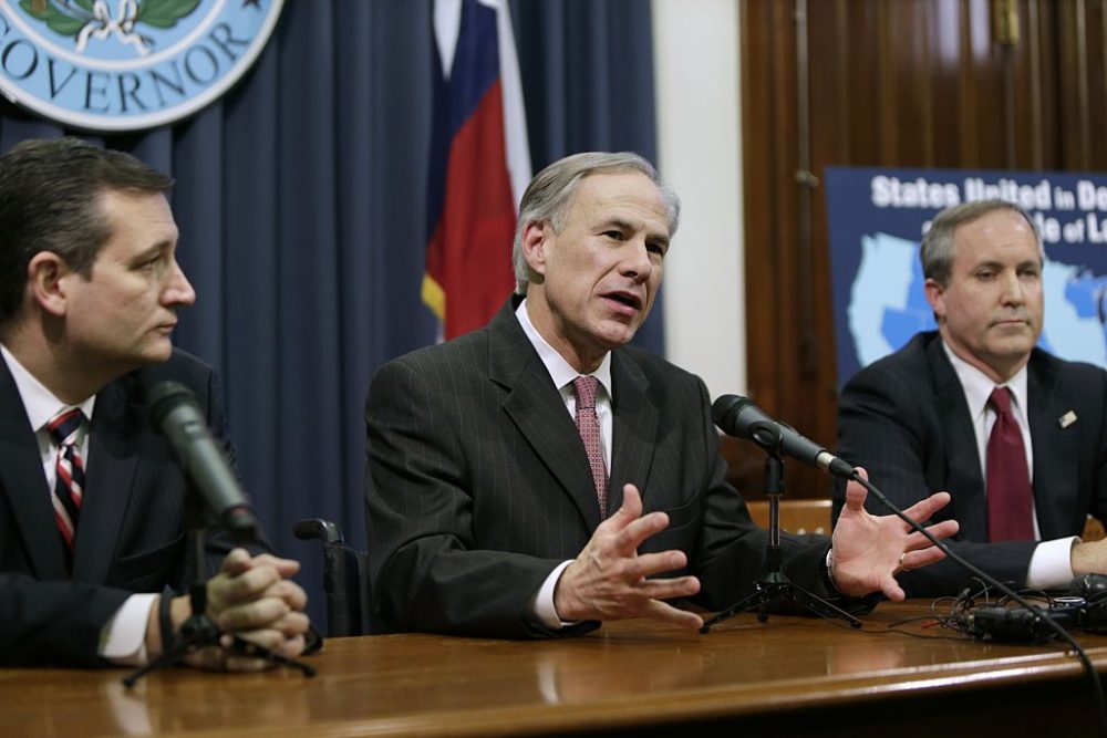 Texas Governor Greg Abbott (center) speaks alongside U.S. Sen. Ted Cruz (R-Texas) (left) and Attorney General Ken Paxton (right) at a joint press conference Feb. 18, 2015 in Austin, Texas. (Erich Schlegel/Getty Images)
