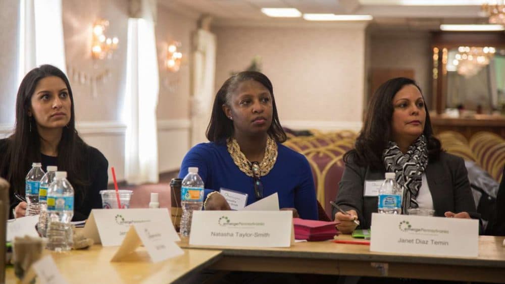 Natasha Taylor-Smith from Montgomery County (center) listens to Anne Wakabayashi, the executive director of EmergePA. EmergePA is a Democratic organization designed to prepare women who want to run for public office. (Emily Cohen for NewsWorks)