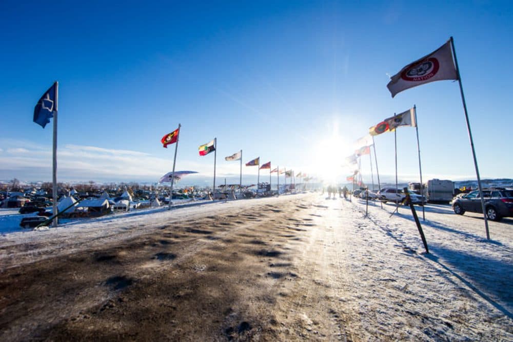 The winter sun shines down Flag Road from the east in the Oceti Sakowin camp where Dakota Access Pipeline protesters settled in for the winter outside of Cannon Ball, N.D. on Sunday, Dec. 4, 2016. (Evan Frost, MPR News)