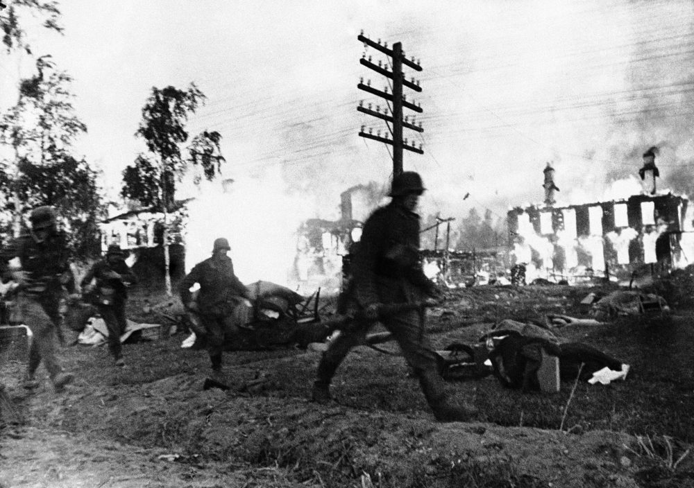 German troops advance through a blazing Leningrad suburb, in Russia on Nov. 24, 1941. (AP)