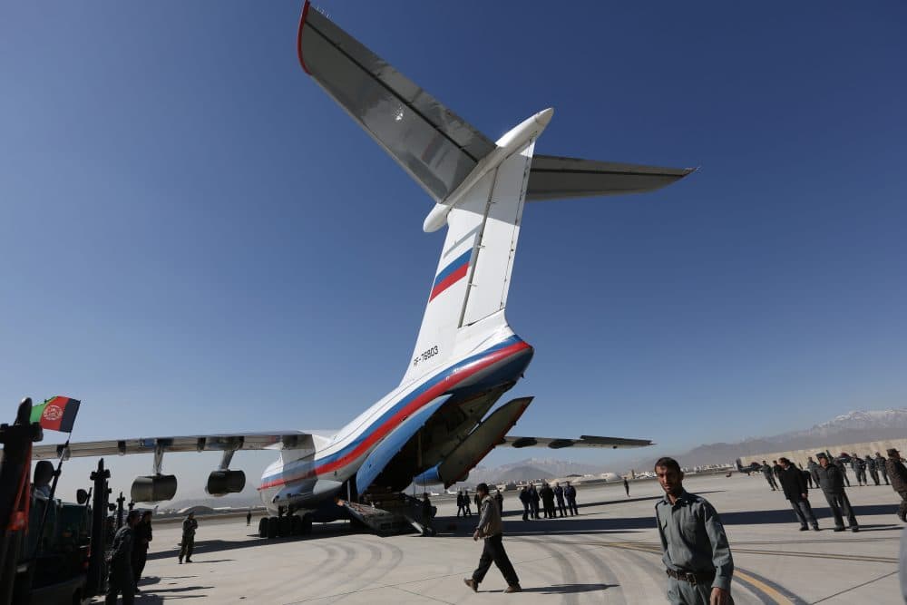 Afghan National Security Forces gather around a Russian aircraft at International Kabul Airport. (Rahmat Gul/AP)