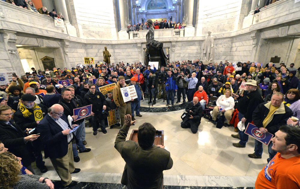 Union leaders speak as protesters fill the Kentucky Capitol rotunda in protest of a House bill making it illegal for workers to have to join a labor union or pay dues to keep a job, in January 2017, in Frankfort, Ky. (Timothy D. Easley/AP)
