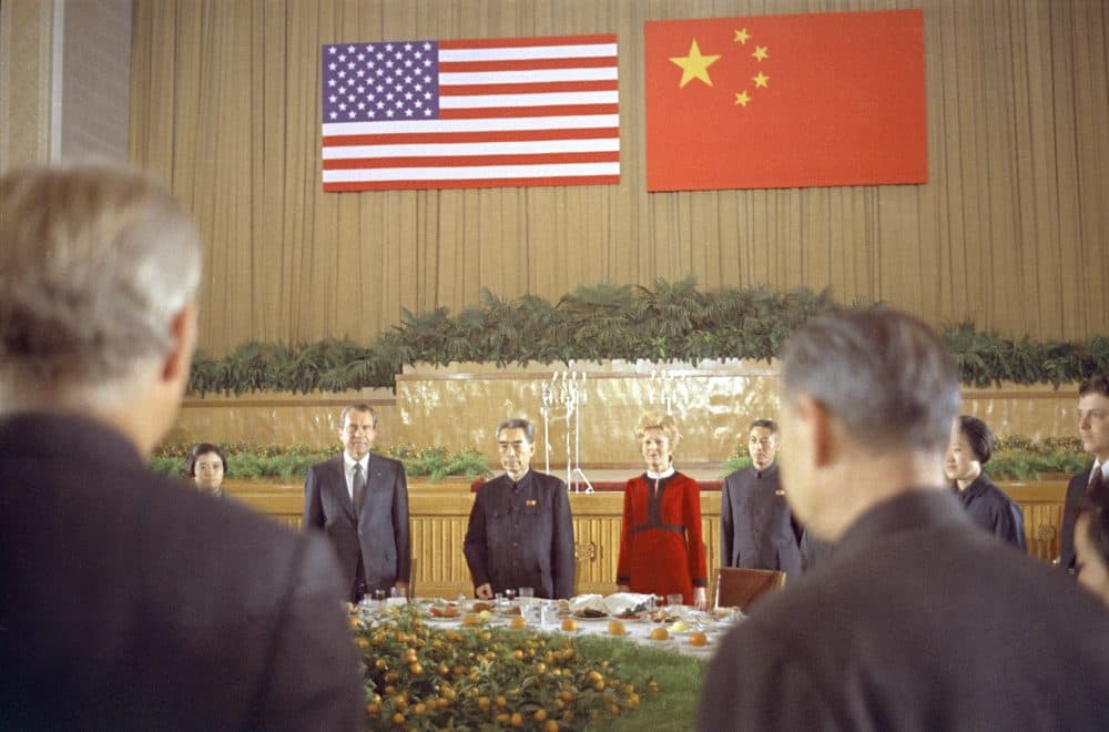 Chinese Premier Chou En Lai is flanked by U.S. President Richard Nixon and first lady Pat Nixon, during a farewell banquet in Shanghai marking the Nixons' last day in China, Feb. 28, 1972. (AP)