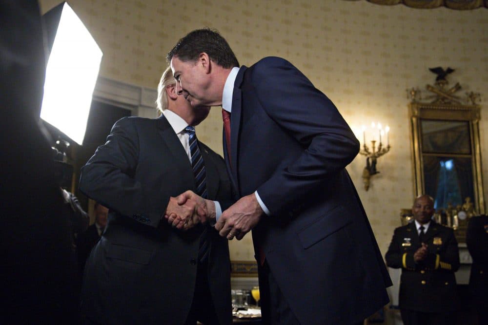 President Donald Trump (left) shakes hands with James Comey, director of the Federal Bureau of Investigation, on Jan. 22, 2017. (Andrew Harrer-Pool/Getty Images)