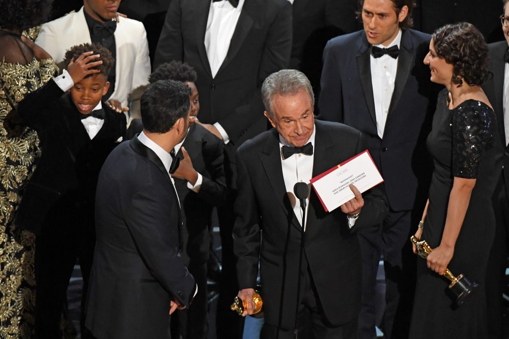 The casts of &quot;Moonlight&quot; and &quot;La La Land&quot; appear on stage as presenter Warren Beatty (center) shows the winner's envelope for Best Picture. (Mark Ralston/AFP/Getty Images)