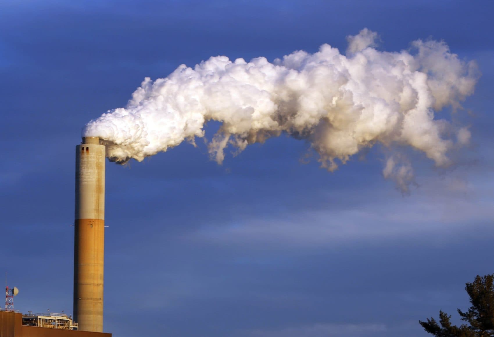 Economists overwhelmingly would vote to tax the carbon content of fuels to curtail climate change. Could the carbon tax win over the climate-change-denying troglodytes in the GOP? Pictured: In this Jan. 20, 2015 file photo, steam billows from the chimney of a coal-fired Merrimack Station in Bow, N.H. (Jim Cole/AP)