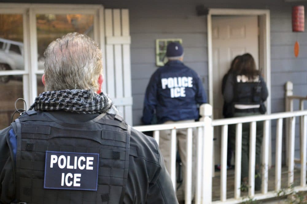 In this Feb. 9, 2017, photo provided U.S. Immigration and Customs Enforcement, ICE agents are seen at a home in Atlanta during a targeted enforcement operation aimed at immigration fugitives. (Bryan Cox/ICE via AP)